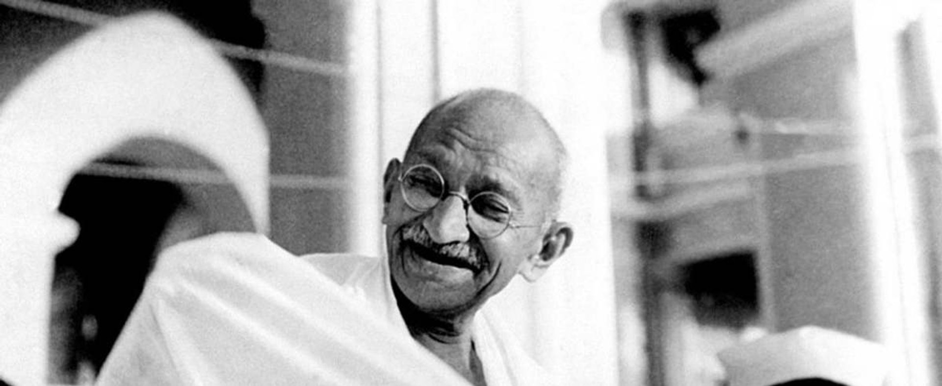Mahatma Gandhi laughing.
