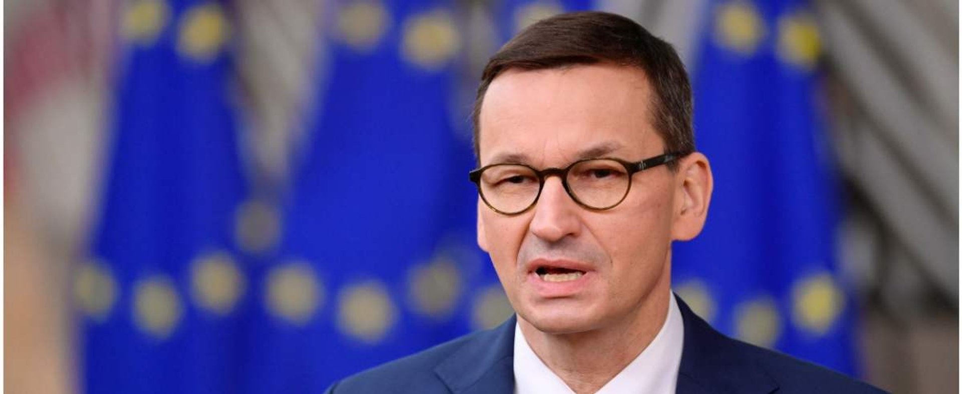 Poland's Prime Minister Mateusz Morawiecki speaks to the press as he arrives at the EU headquarters' Europa building in Brussels on December 10, 2020, prior to a European Union summit. (Photo by JOHN THYS / POOL / AFP)