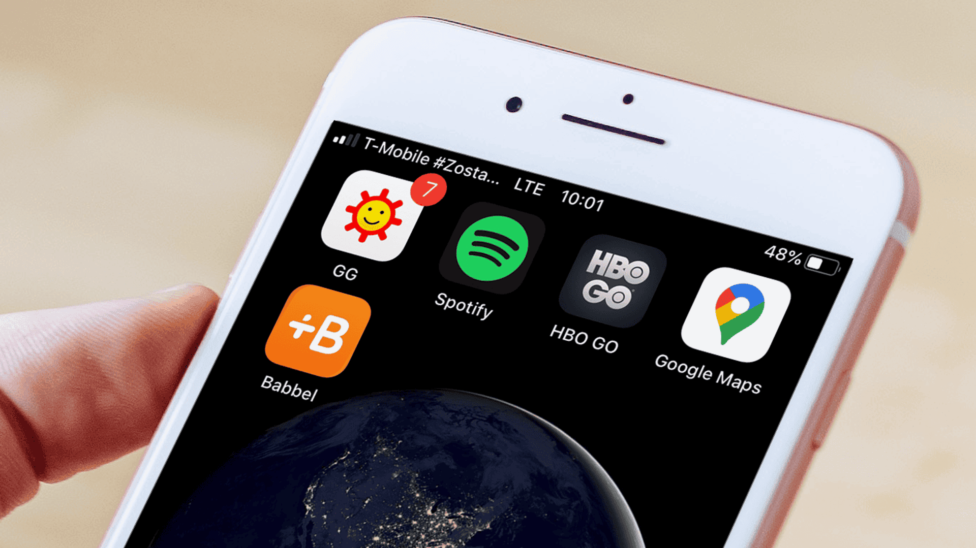 telefon komórkowy z wyświetlonymi na ekranie ikonami GG, Spotify