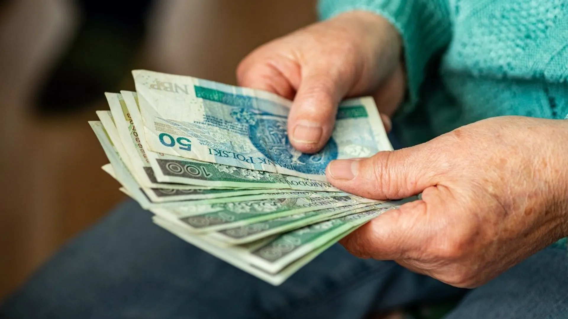 Kobieta trzyma w rękach pieniądze