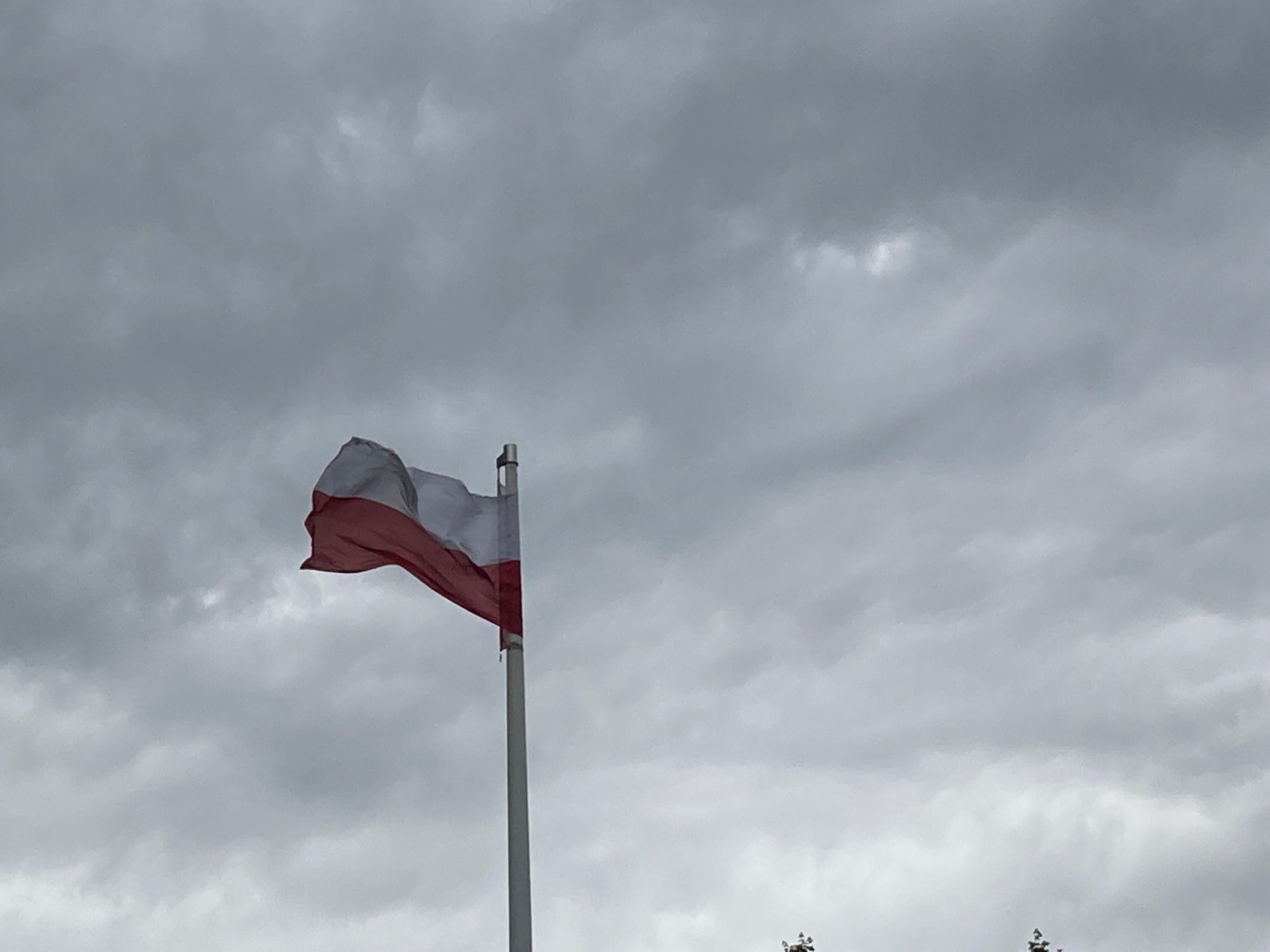 flaga Polska-wiatr-chmury-biznesinfo.JPG
