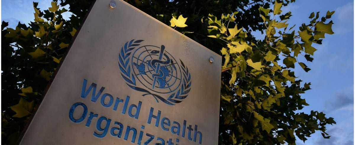 A photo taken in the late hours of August 17, 2020 shows a sign of the World Health Organization (WHO) at their headquarters in Geneva amid the COVID-19 outbreak, caused by the novel coronavirus. (Photo by Fabrice COFFRINI / AFP)