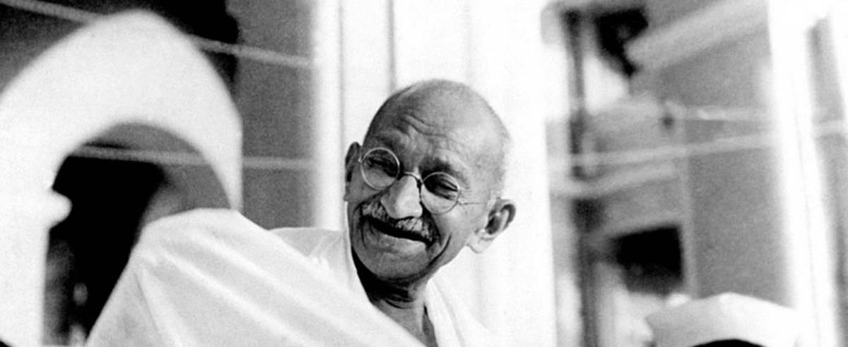 Mahatma Gandhi laughing.